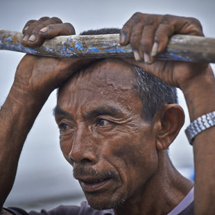 Fisher man resting at hes outrigger, Eastern Java