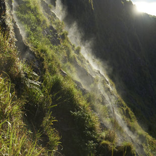 Hot steam shows on the inside the crater of activ Batur, Bali