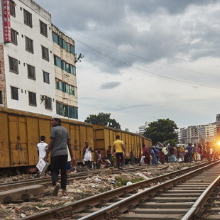 Raliways is a rear but cheap way of transport. Trains runs slow through this slum area. 