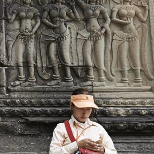 Chines visitor with her smart phone, Angkor Wat